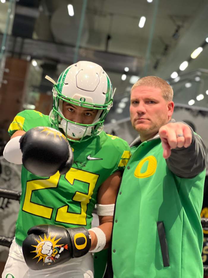 Marco Jones poses with defensive coordinator Tosh Lupoi.